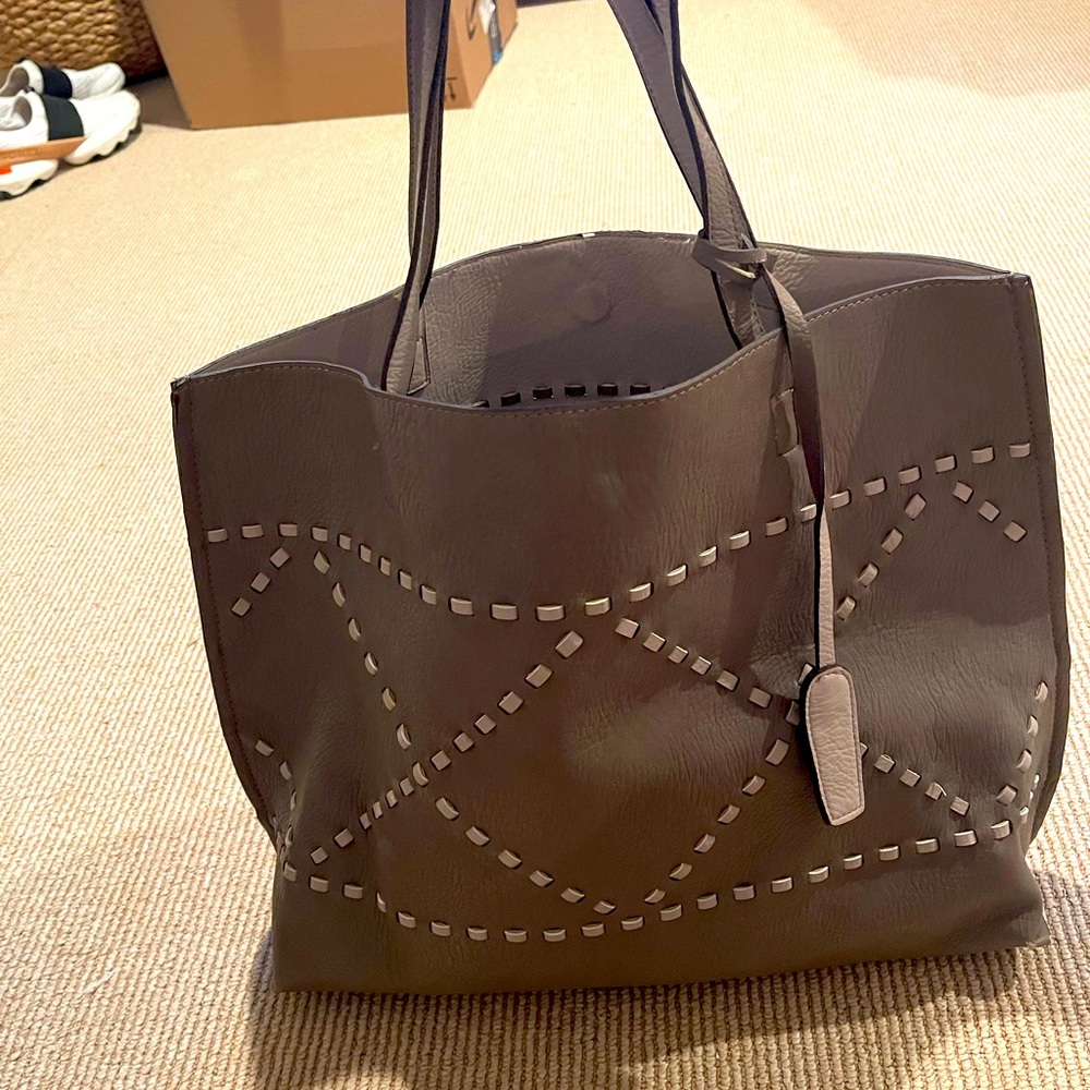 Grey leather bag with lighter grey stitching and small zip pouch